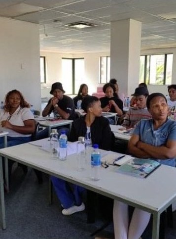 Candidates seated at long tables during a Thuto Tutorials class