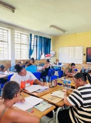 Candidates working through study material in a classroom